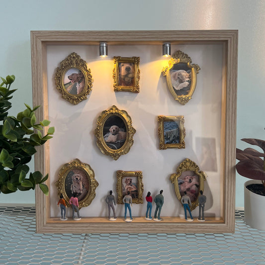 Decorative wall art with framed pictures of a dog and small figures in front.